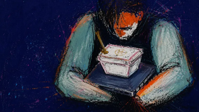 A person eating dinner off a laptop in bed, showing how people-pleasing can shrink home into a small