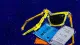 Bent sunglasses squeezed against a transit pass and receipt, echoing the pressure to make a warm day