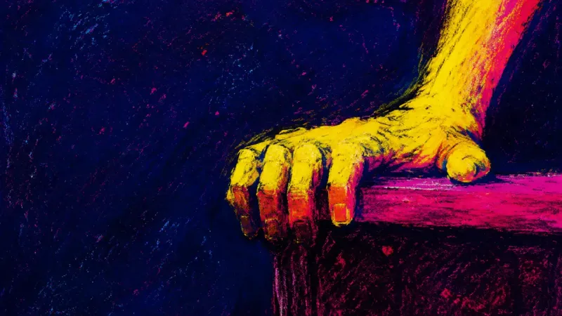 A hand grips a dining-table edge, symbolizing the guilt that triggers an immediate yes before a p