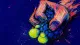 Composure Under Pressure A hand crushes a stress ball through its torn net sleeve, symbolizing the effort to contain feelings