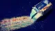 Revision Without End A study eraser worn into a split wedge over repeatedly revised plan headings, symbolizing paralysis