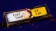 A desk nameplate stuck between two labels, symbolizing paralysis between contacting a coworker and**
