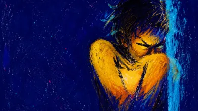 A solitary figure with raised shoulders and an inward-folded torso, amber light pressing into deep indigo and cyan space.