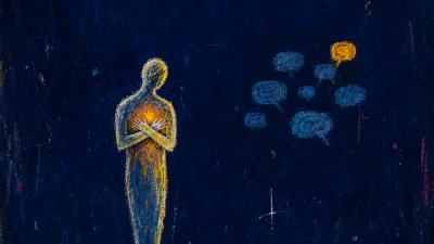 A still figure with hands clasped over the ribs beside a dimmed chat screen, amber light compressed into cold blue shadow