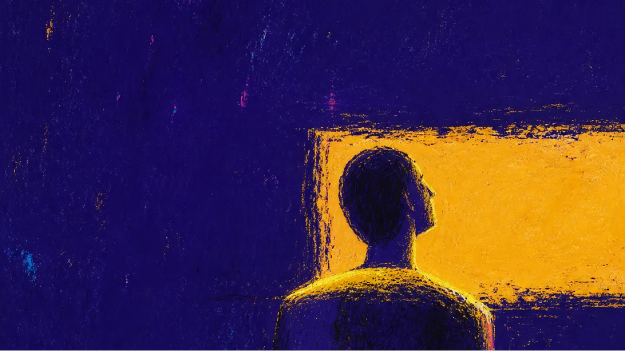 Message Light Settling Across Shoulders A half-turned figure stands still as amber screen light settles across the shoulders, widening a gap in deep indigo space.