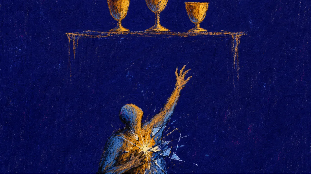Reaching for the finished self A figure on the floor reaches toward glowing cups above, one hand on their chest, amber light splitting into cold blue shadow
