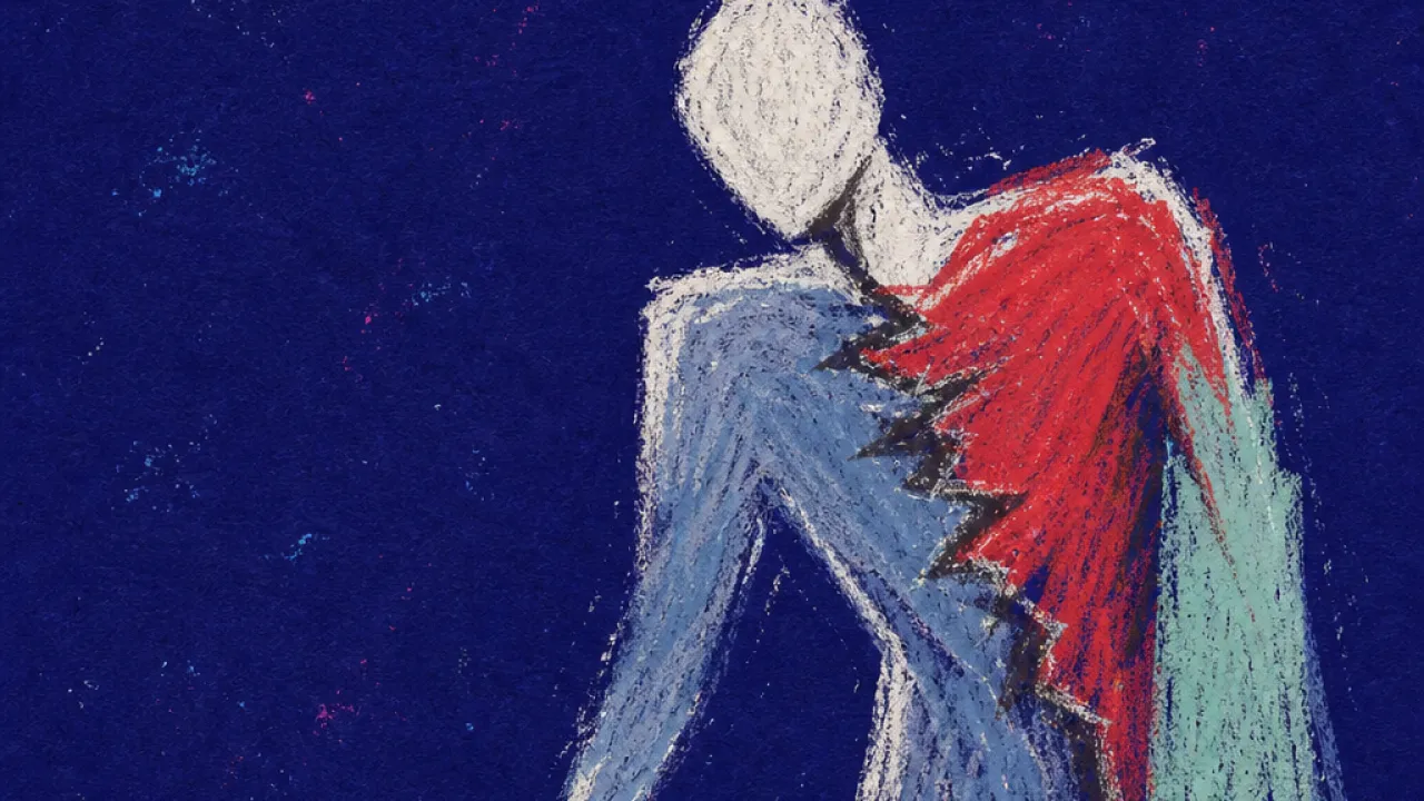 A forward-leaning figure reaches for keys beside an open laptop, with red light cutting into cold blue-gray shadows