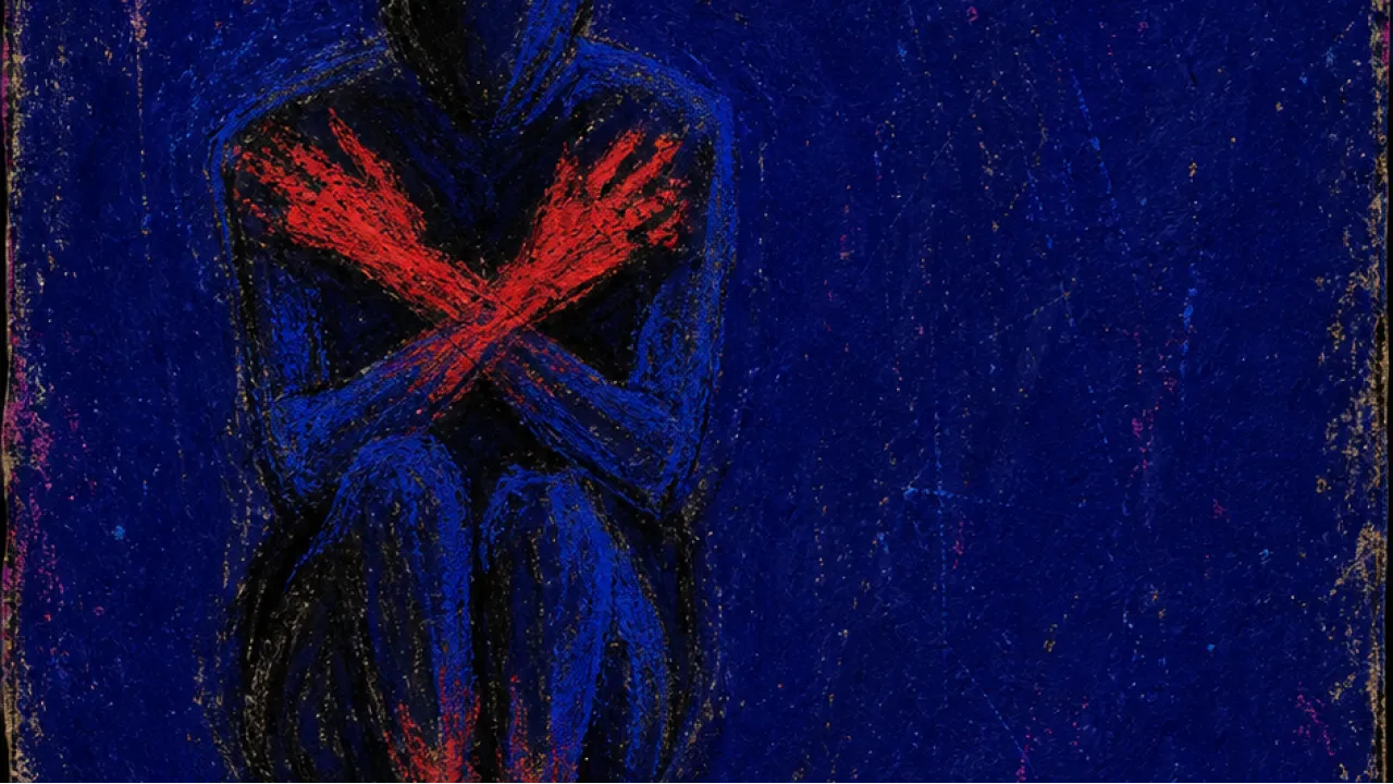 An enclosed figure in a dark chamber with folded arms, red light at the hands and feet against sealed blue-black space